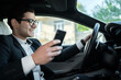 © muse studio - The driver uses the phone in the car