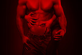 Fototapeta  - Sexy young couple body at night in red light closeup