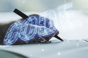 Poster - Creative Code word sign and man hand writing in notepad on background, international software development concept. Multiexposure