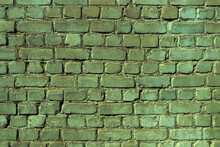 An Old Damaged Brick Wall Colored In Green As A Background
