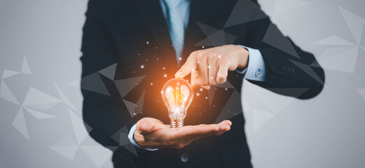 Poster - Creativity in the hands of business people idea concept, Businessman holding glowing light bulb with drawing brain and connection line, creative thinking ideas and innovation technology and creativity