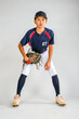 Male youth baseball player watching for the ball with glove ready