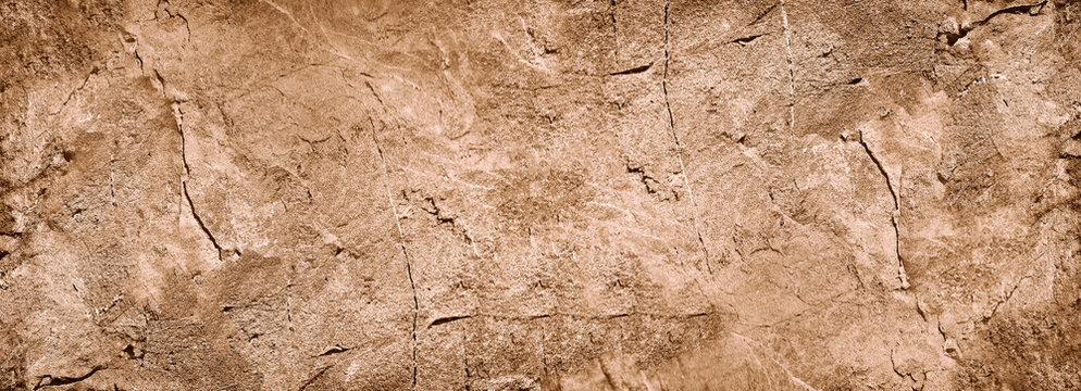Wall Mural -  - Light brown rock texture. Rough mountain surface. Close-up. Beige stone background with space for design. Web banner. Wide. Panoramic. Sandstone. Solid, rocky, slate.