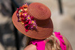 A women wearing a floral decretive hat at a horse race.