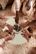 Hands Of Young Women Putting Stones In Saucer For Lithomancy Practice