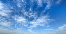 White Clouds Against Blue Sky Background