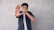 © Muhammad Alfian  - Asian man shuts mouth and hands stop