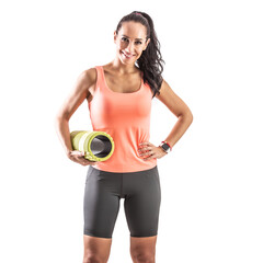 Wall Mural - Female fitness instructor holds foam roller and smiles into the camera