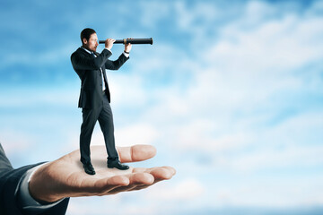 Canvas Print - Abstract image of businessman with telescope looking into the distance while standing on palm. Future, market research and success concept. Clouds and sky background with mock up place.