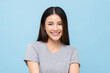 Portrait of pretty southeast Asian girl smiling in light blue color isolated studio background