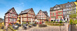 canvas print picture - Ensemble von Fachwerkhäusern, am Kornmarkt in der historischen Altstadt von Wetzlar, Hessen mit einem menschleeren Straßencafe