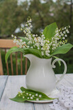 Fototapeta Nowy Jork - Bouquet of lilies of the valley in an antique white ceramic jug.