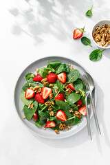 Sticker - Strawberry and spinach salad with walnuts, top view