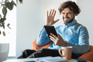 Aufkleber - Business man using tablet waving hand making video call