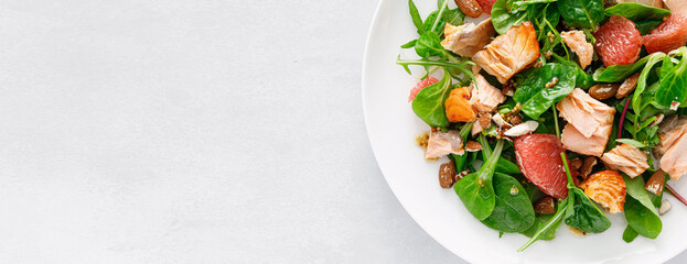 Canvas Print - Grilled salmon salad with grapefruit, almonds and salad mix. Top view. Banner