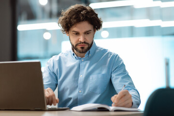 Aufkleber - Portrait of focused businessman using laptop and writing