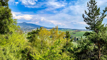 View From Krkavčí Skály (Vajoletky) To Ještěd Ridge. Rocks Near Křižany Near Ještěd In The Liberec Region. Spring Romantic Landscape In The Czech Republic.