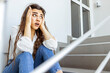 Business women are stressed from work while sitting in front of the stairs The balance of work life, the concept of fatigue from pressing business problems in the Covid period.