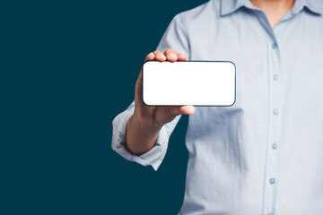 Wall Mural - hand holding a blank screen smartphone while standing on a blue background