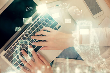 Poster - Double exposure of woman hands working on computer and envelop hologram drawing. Top View. E-mail concept.