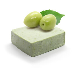 Natural handmade olive oil soap and two olives on white background