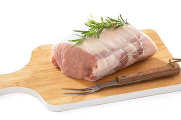 raw pork roast on a board on a wooden background