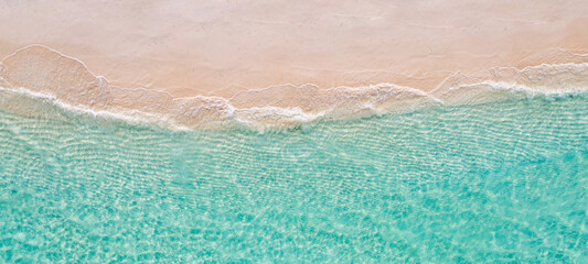 Wall Mural - Relaxing aerial beach scene, summer vacation holiday template banner. Waves surf with amazing blue ocean lagoon, sea shore, coastline. Perfect aerial drone top view. Peaceful bright beach, seaside