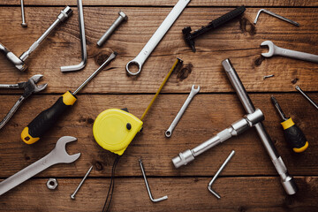 Flat lay with DYI composition of various work, carpentry tools knolled on brown wooden decks background pattern working table. Top view on new hand tool set for repair and construction kit, overhead