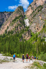 Wall Mural - mountain hikers on a path in a canyon