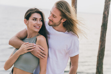 Poster - Photo of dreamy adorable two people together hugging enjoying good weather walking outside ocean water