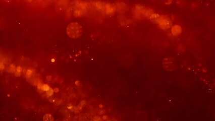 Wall Mural - Abstract wavy movement of golden shiny particles in red. Dust Particles Background. Shot of real gold particles floating in the red water.