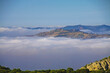 Beautiful early quiet morning mountains landscape, sea of low layer stratus clouds, mountain peak - Montes de Malaga, Spain 