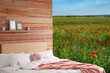 © New Africa - Comfortable bed with soft pillows in in poppy field on sunny day