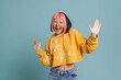 Asian girl with pink hair and piercing expressing surprise at camera