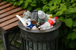 Trash bin or garbage can overflowing empty bottles