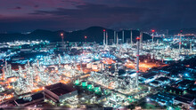 Aerial View Of Factory Zone Oil And Gas Industry - Refinery Stores Tank And Petrochemical Plant On Island At Twilight Over Lighting