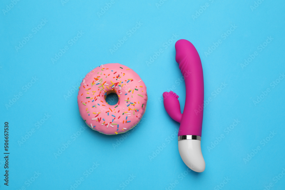 Pink vaginal vibrator and donut on light blue background, flat lay Stock  Photo | Adobe Stock