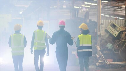 Wall Mural - Walking Professional team working at workplace. Unity and teamwork concept. Portrait engineer factory manager worker and mechanic team together in factory workplace