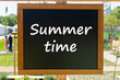 © kelifamily - Black chalkboard with the inscription Summertime in the garden