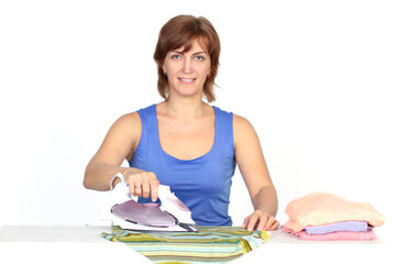 Wall Mural - Young smiling woman is ironing a shirt with a shirt iron on white background.