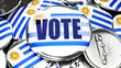 © GoodIdeas - Uruguay and Vote - dozens of pinback buttons with a flag of Uruguay and a word Vote. 3d render symbolizing upcoming Vote in this country.,3d illustration