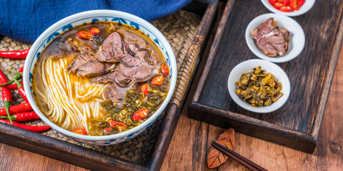 Old altar beef noodles with pickled cabbage on wooden table