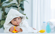 © Ann Rodchua - Adorable caucasian little baby daughter girl, wearing cute white bathrobe, taking bath in morning, crawling on floor with copy space, smiling with happiness at home or house. Kid Development Concept.