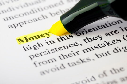 Investment Text Macro Shot Highlighted with a Highlighter in Yellow Color On Printed Paper