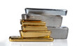 A pile a gold and silver bars of different weight isolated on white background.