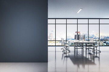 Poster - Front view on blank black wall in night open space office with work tables and chairs, modern computers and transparent wall with night city view and street lights. 3D rendering, mock up