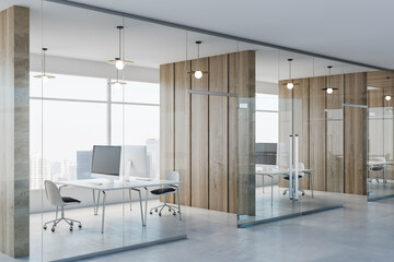 Poster - Side view on modern spacious coworking office with wooden wall partitions, modern computers on minimalistic style tables, concrete floor and glass wall instead windows. 3D rendering