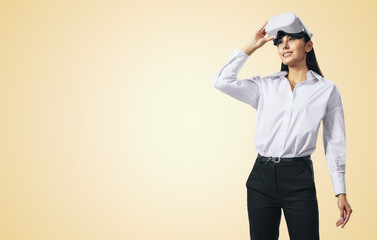 Aufkleber - Virtual reality concept with young woman looking up and VR headset on her head on abstract light orange background with place for your logo or text, mock up