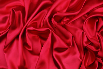 Closeup of rippled red silk fabric texture