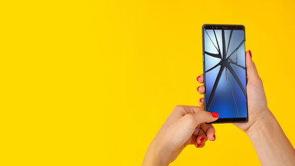 Poster - Woman holds smartphone with broken screen. Broken glass smartphone screen in girl's hands. Place for text on yellow. Failure, damaged equipment, repair of equipment. Advertising of the service center